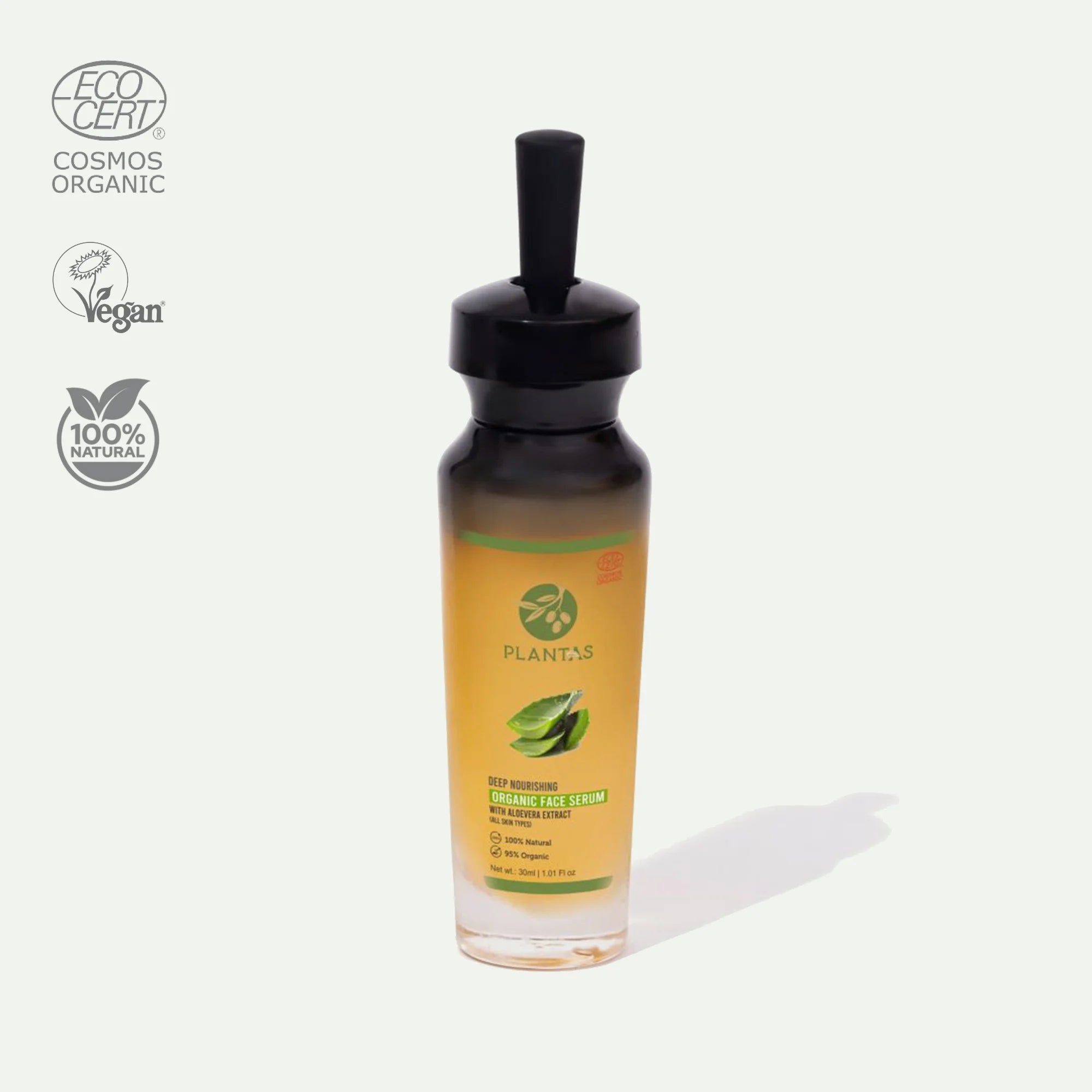 A bottle of Plantas Organic Face Serum with a black dropper, labeled with the brand's logo and organic certification symbols.
