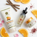 Skincare products with oranges, cinnamon sticks, and saffron on a white background